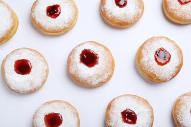 Hanukkah doughnuts with jelly and sugar powder on white background, top view