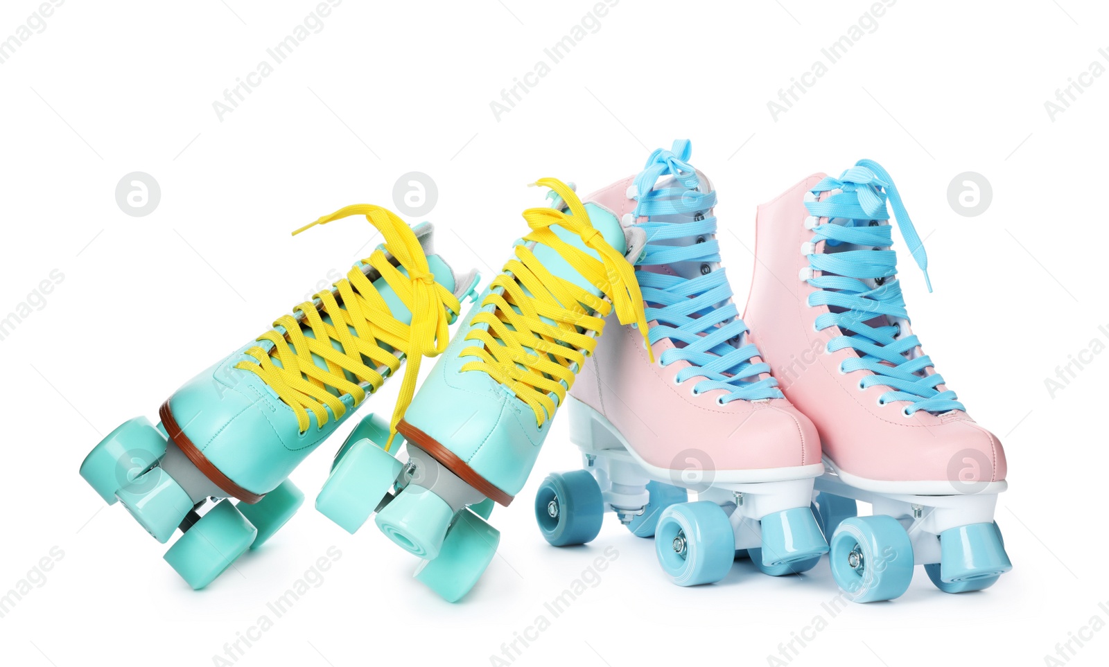 Photo of Pairs of bright stylish roller skates on white background