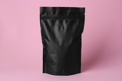 Photo of One blank foil package on pink background