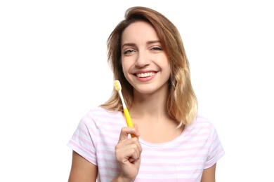 Photo of Portrait of young woman with toothbrush on white background