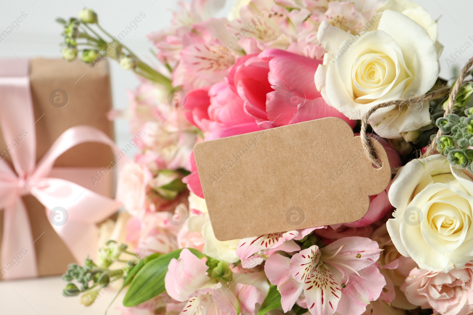 Photo of Happy Mother's Day. Beautiful flowers with blank card on light background, closeup