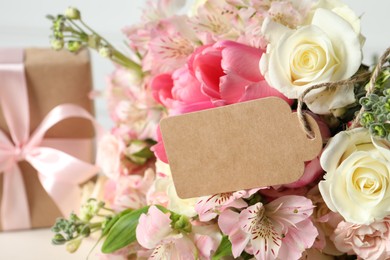 Photo of Happy Mother's Day. Beautiful flowers with blank card on light background, closeup