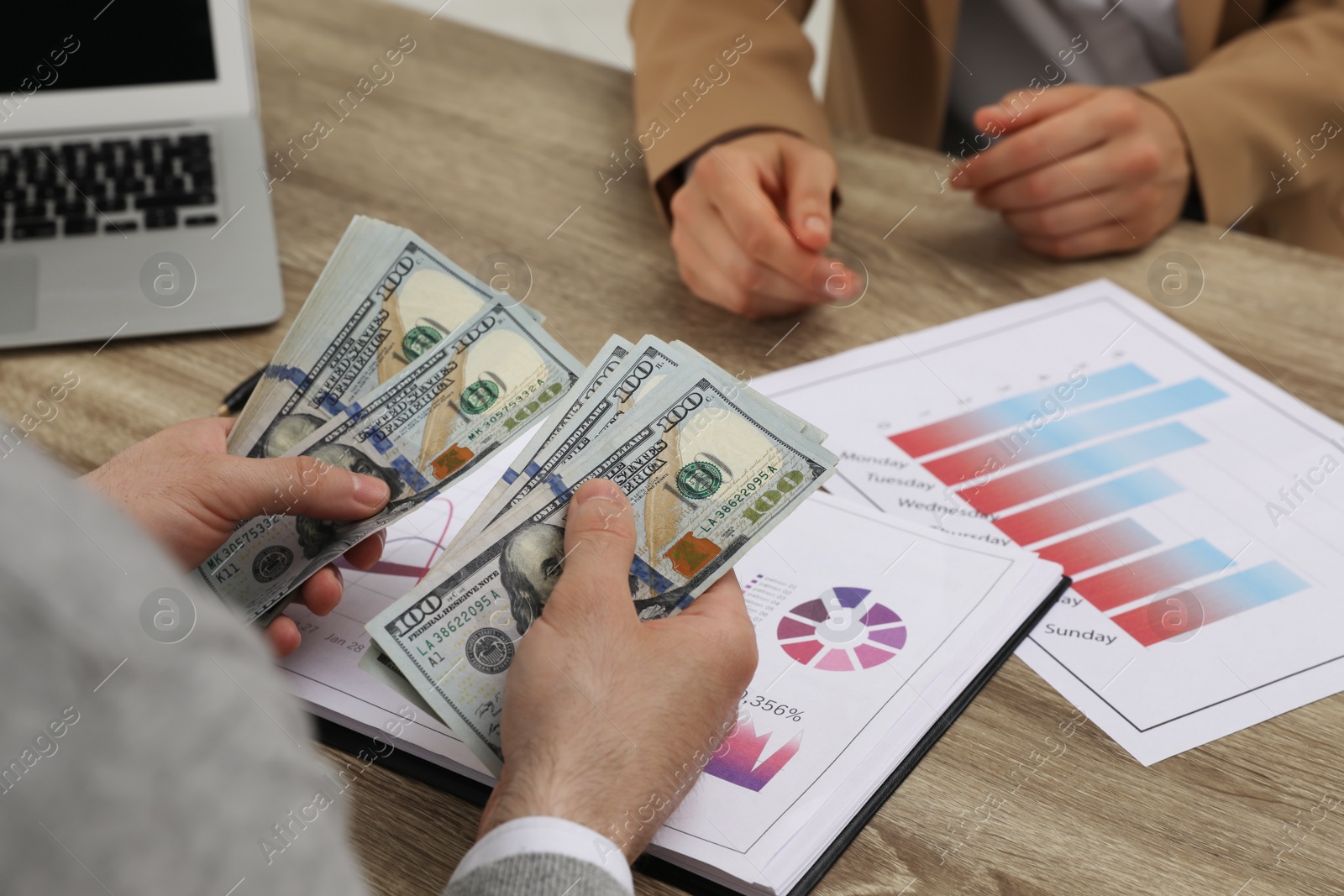 Photo of Cashier counting money at desk in bank, closeup