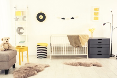 Photo of Stylish baby room interior with crib