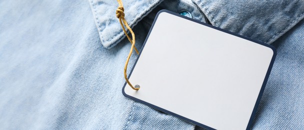 Image of Blank tag on denim shirt, closeup view with space for text. Banner design