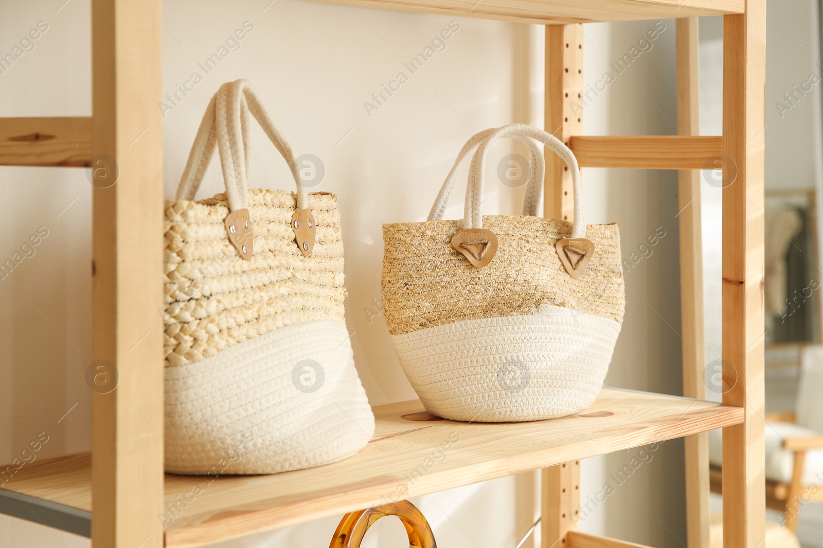 Photo of Stylish woman's bags on shelf in boutique