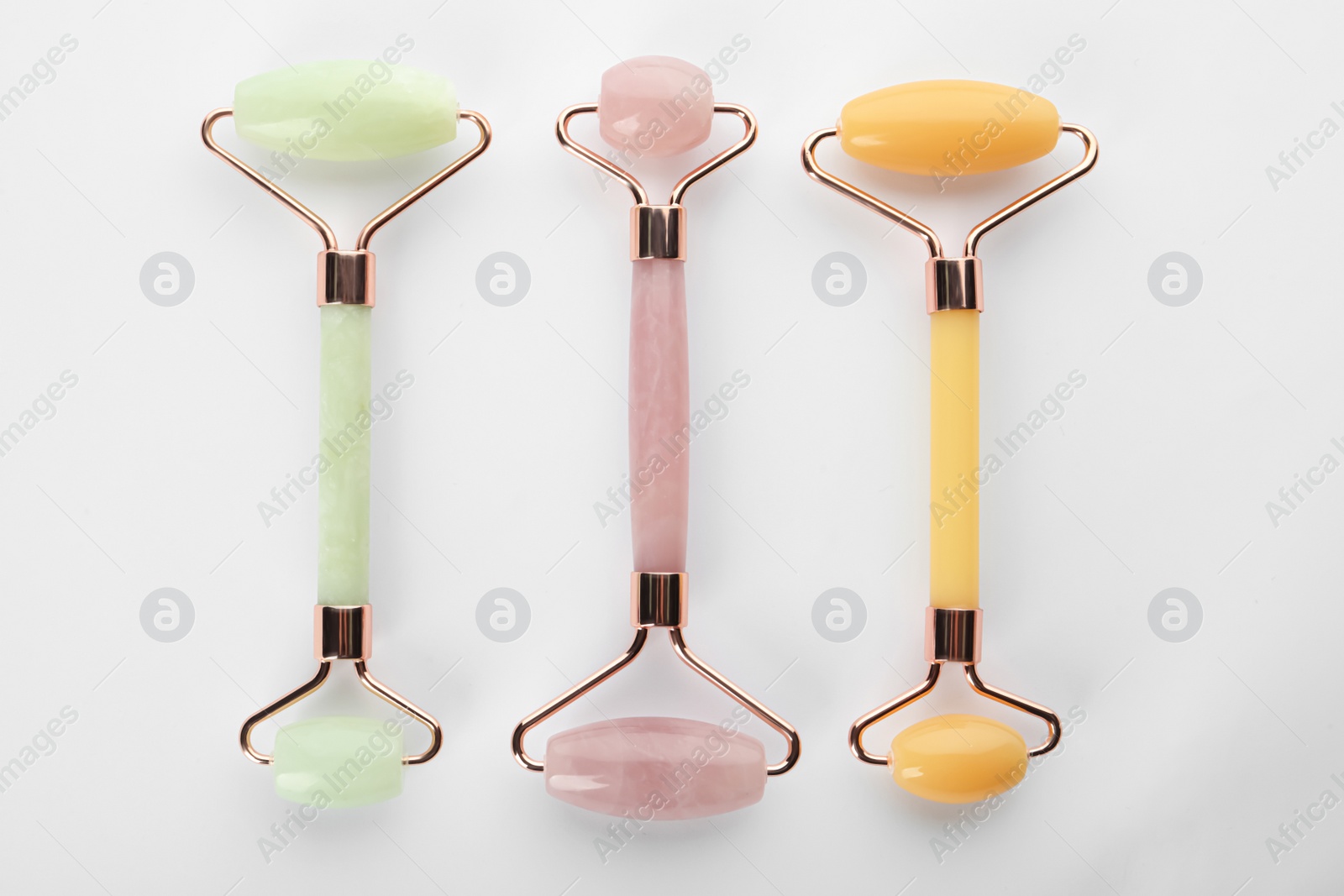 Photo of Different natural face rollers on white background, top view