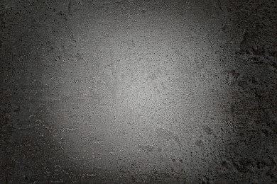 Image of Texture of dark grey stone surface spot of light as background, top view