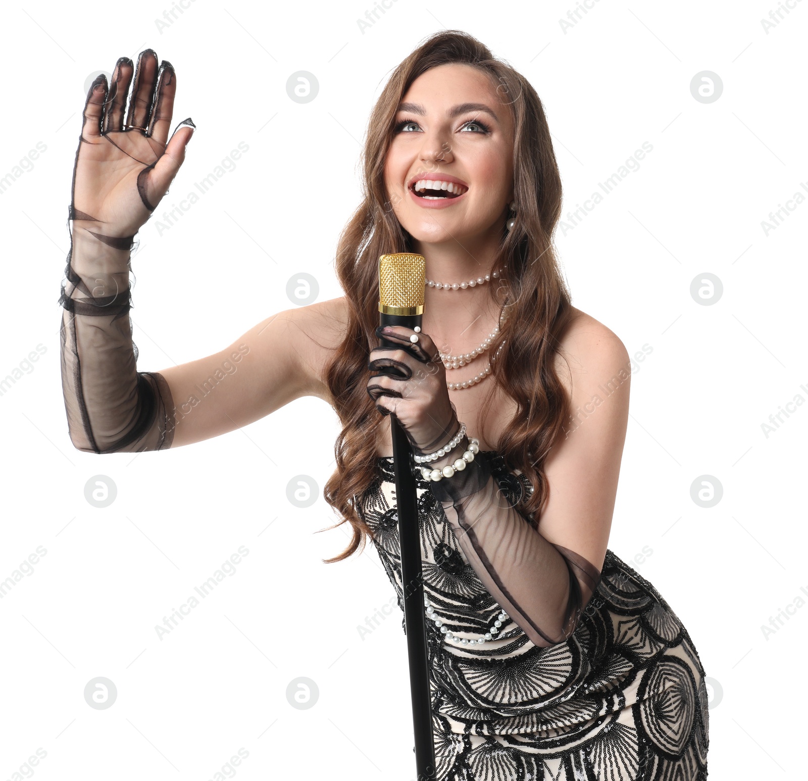 Photo of Beautiful young woman in stylish dress with microphone singing on white background