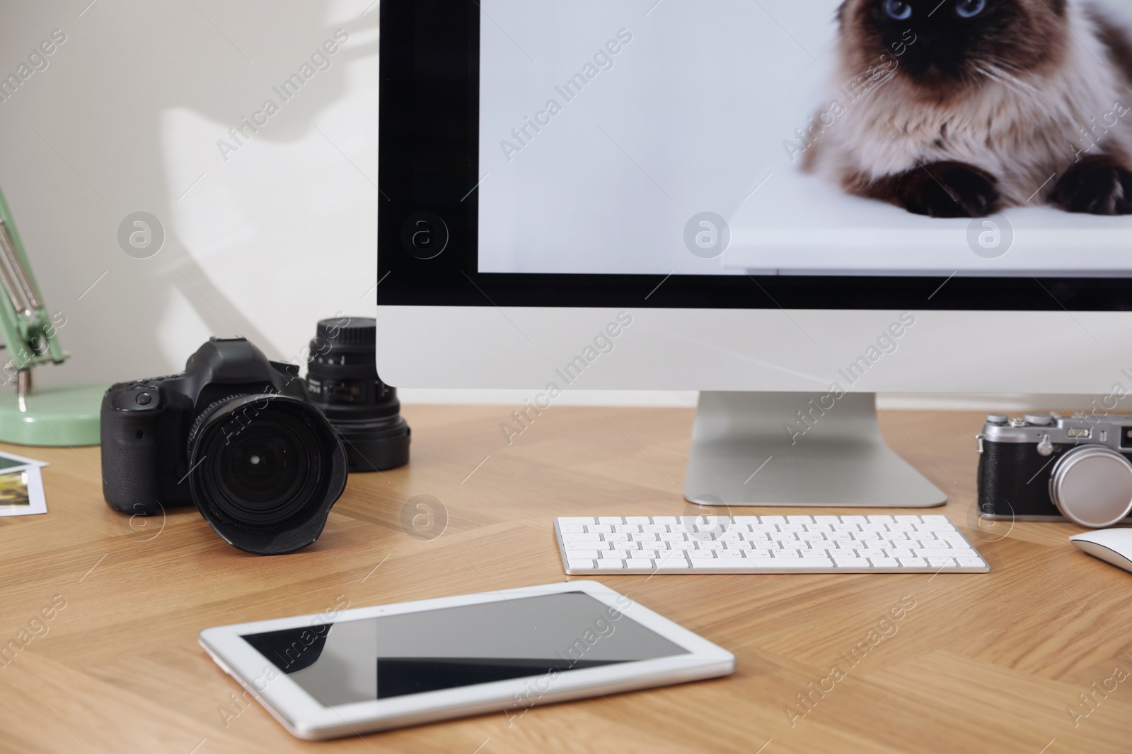 Photo of Photographer's workplace with professional camera in office