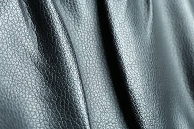 Black natural leather as background, closeup view