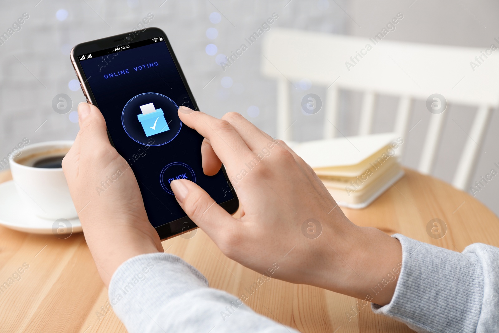 Image of Woman voting online via smartphone at table, closeup