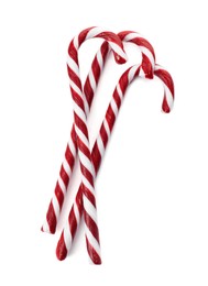 Photo of Delicious Christmas candy canes on white background, top view