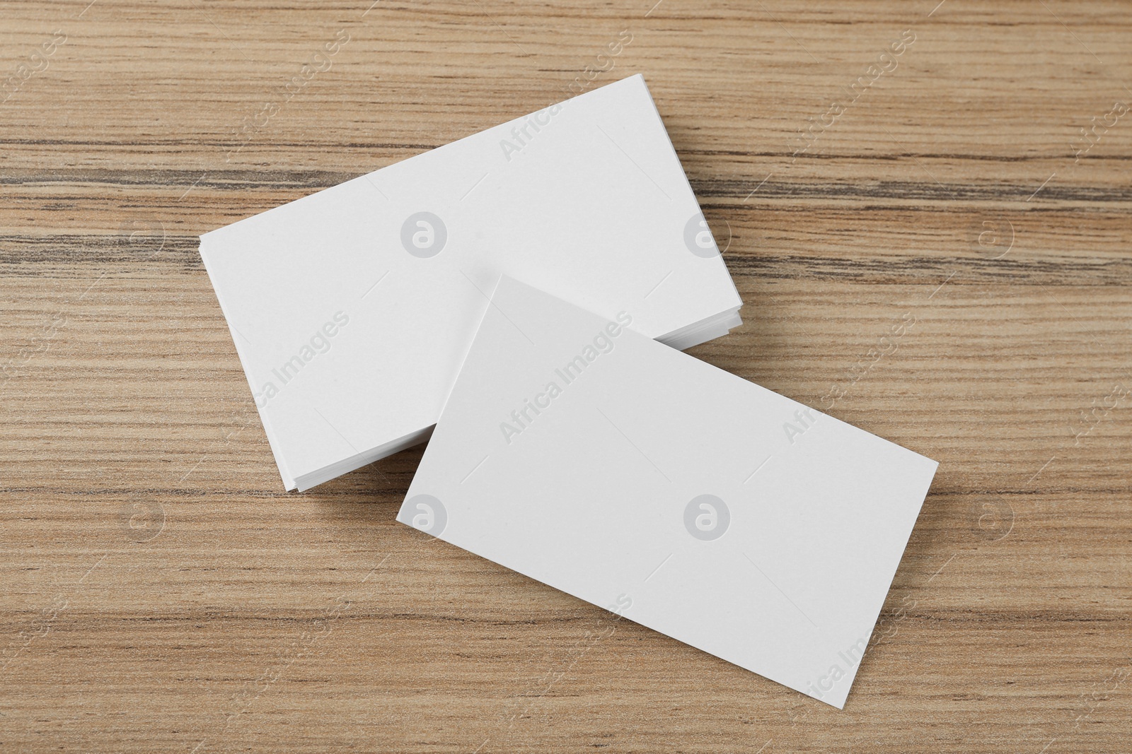 Photo of Blank business cards on wooden background, flat lay. Mockup for design