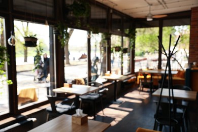 Photo of Blurred view of cafe interior with bokeh effect