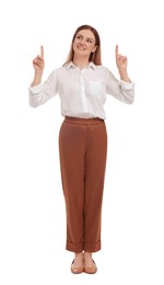 Photo of Beautiful businesswoman pointing at something on white background