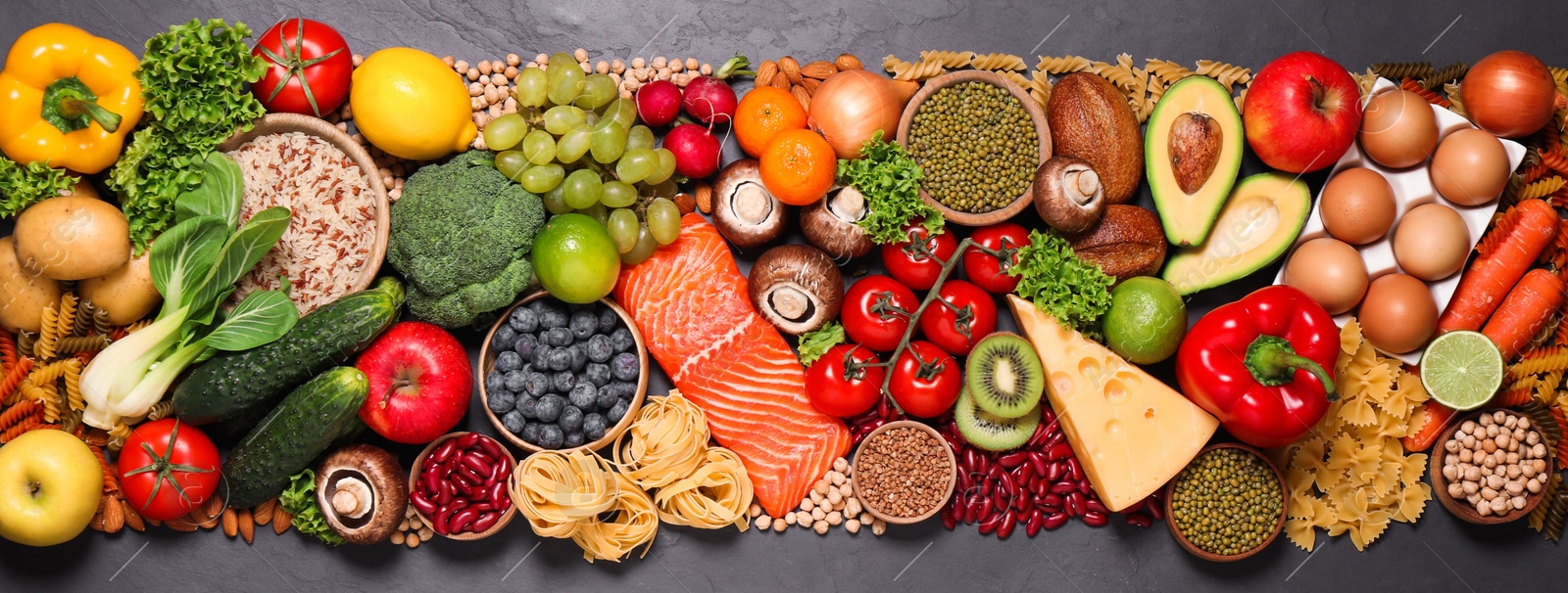 Photo of Different products on black table, top view. Healthy food and balanced diet