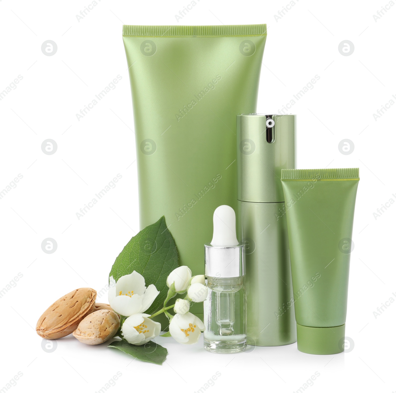 Photo of Set of cosmetic products, almond nuts and flowers isolated on white