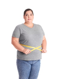 Overweight woman measuring waist before weight loss on white background