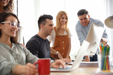 Photo of Team of professional designers working in office