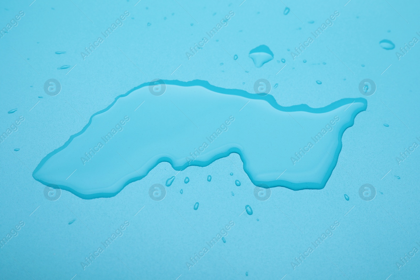Photo of Puddle of water on light blue background, above view