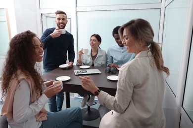 Team of employees enjoying coffee break together in office. Startup project