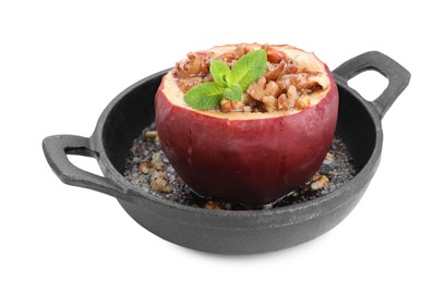 Tasty baked apple with nuts, honey and mint in baking dish isolated on white