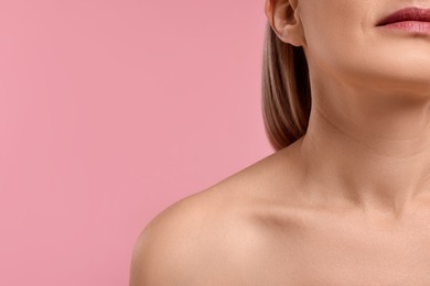 Woman with healthy skin on pink background, closeup. Space for text