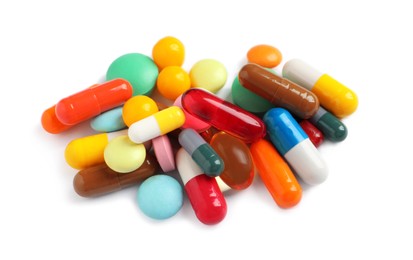 Photo of Pile of different colorful pills on white background, above view