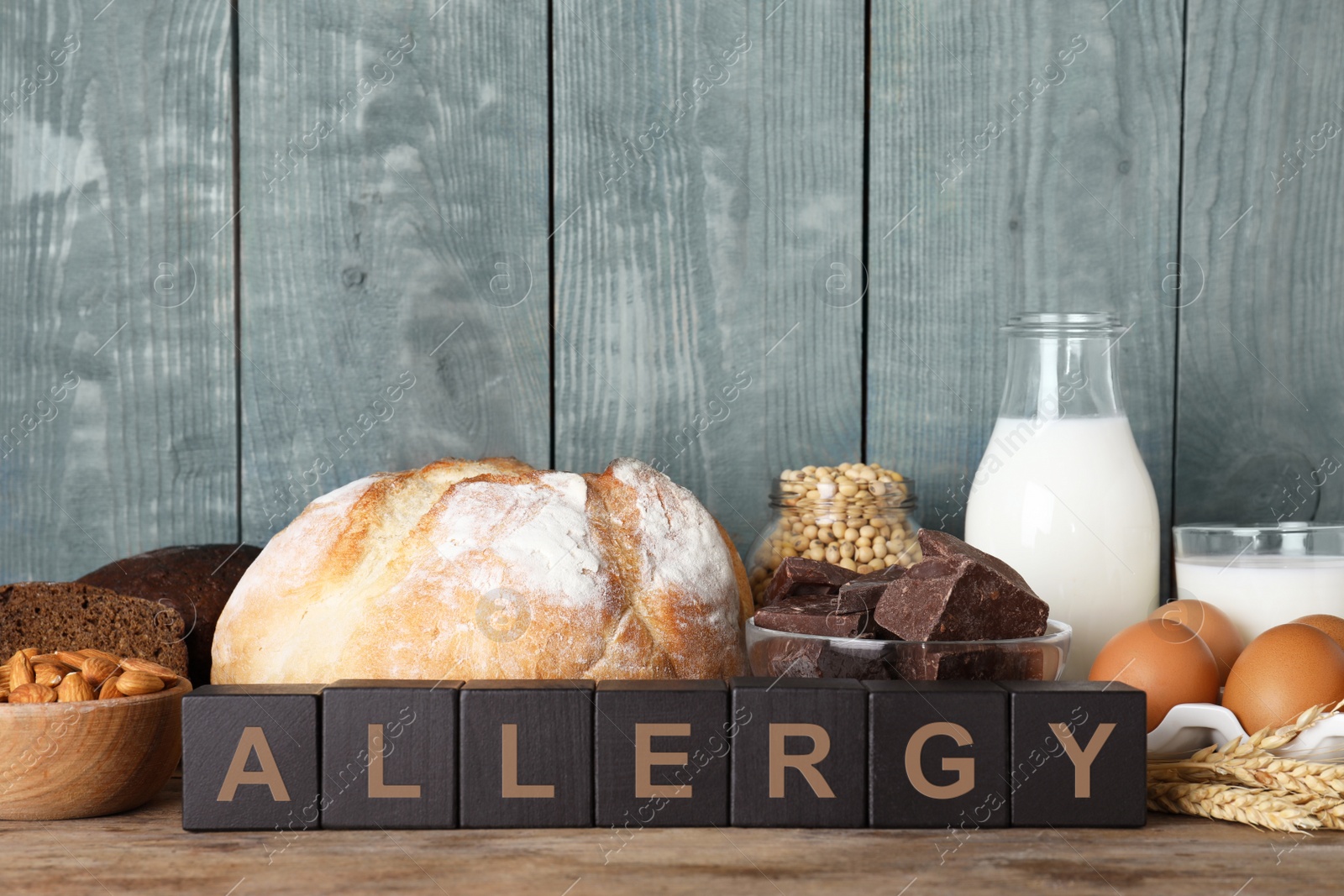 Photo of Different products on wooden background. Food allergy concept
