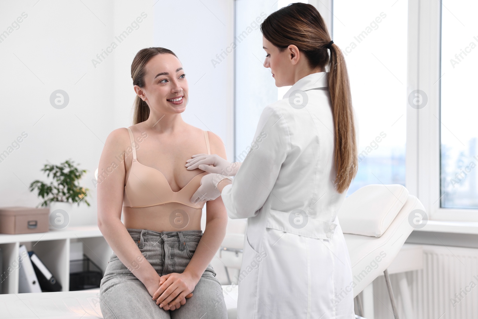 Photo of Mammologist checking young woman's breast in hospital