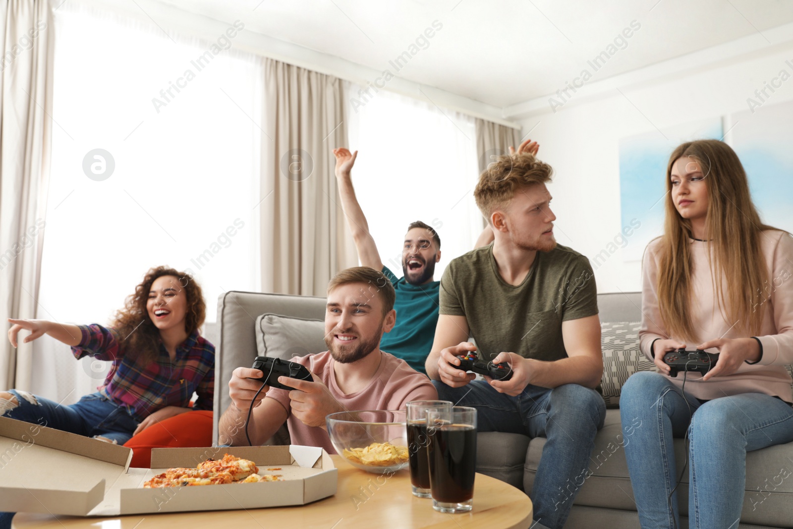 Photo of Emotional friends playing video games at home