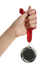 Photo of Woman holding silver medal on white background, closeup. Space for design