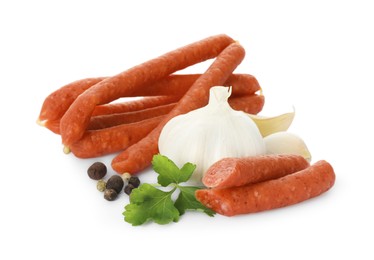 Photo of Thin dry smoked sausages and different spices isolated on white