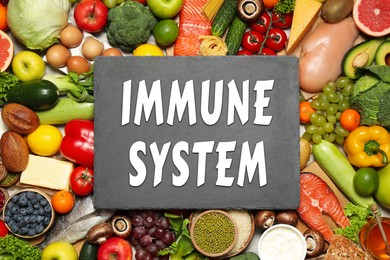 Image of Immune system boosting with proper nutrition. Different foods and slate plate, flat lay