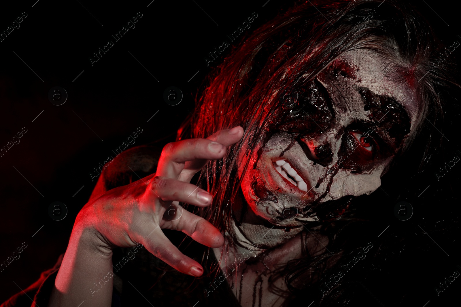 Photo of Scary zombie on dark background, closeup. Halloween monster