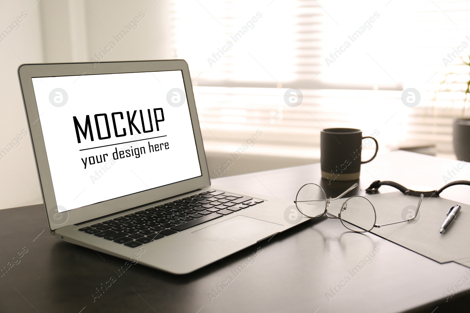 Image of Modern laptop with text Mockup Your Design Here on screen