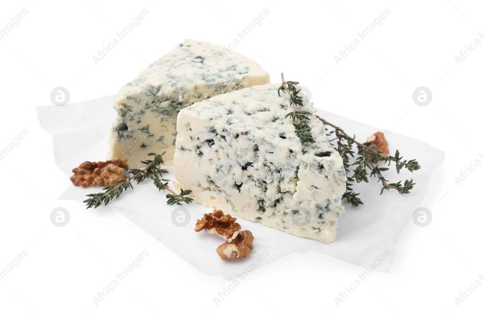 Photo of Tasty blue cheese with thyme and walnuts isolated on white