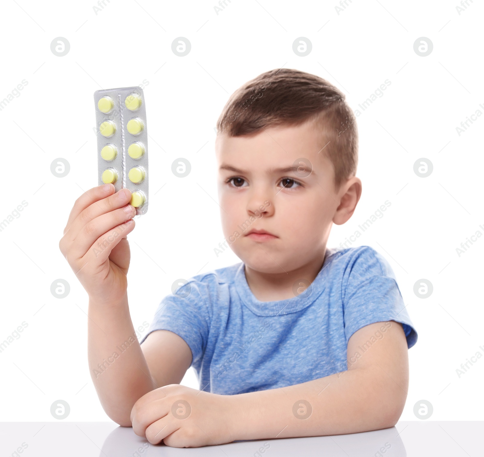 Photo of Little child with pills on white background. Household danger