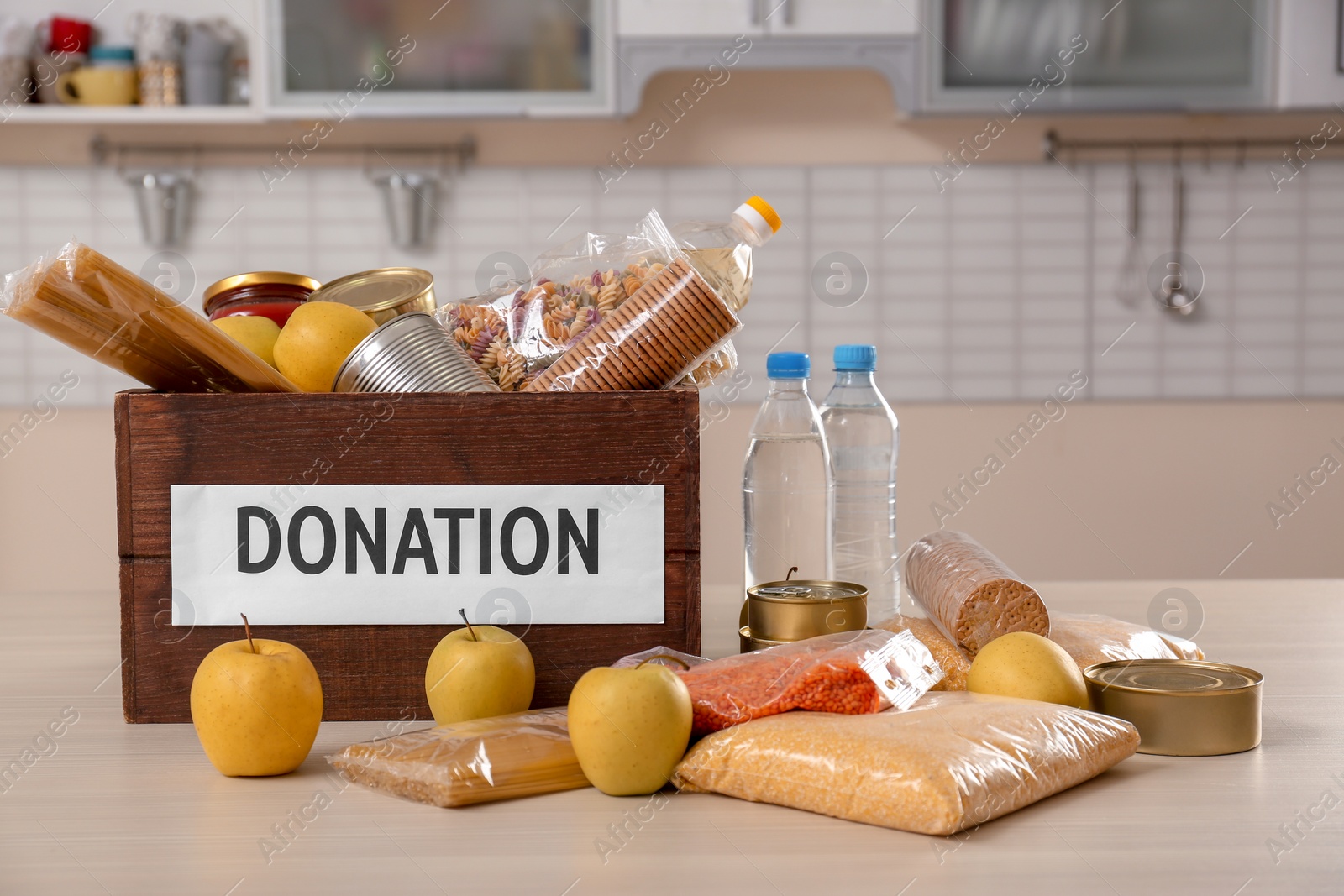 Photo of Donation box and different products on table indoors