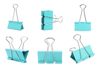 Set with light blue binder clips on white background