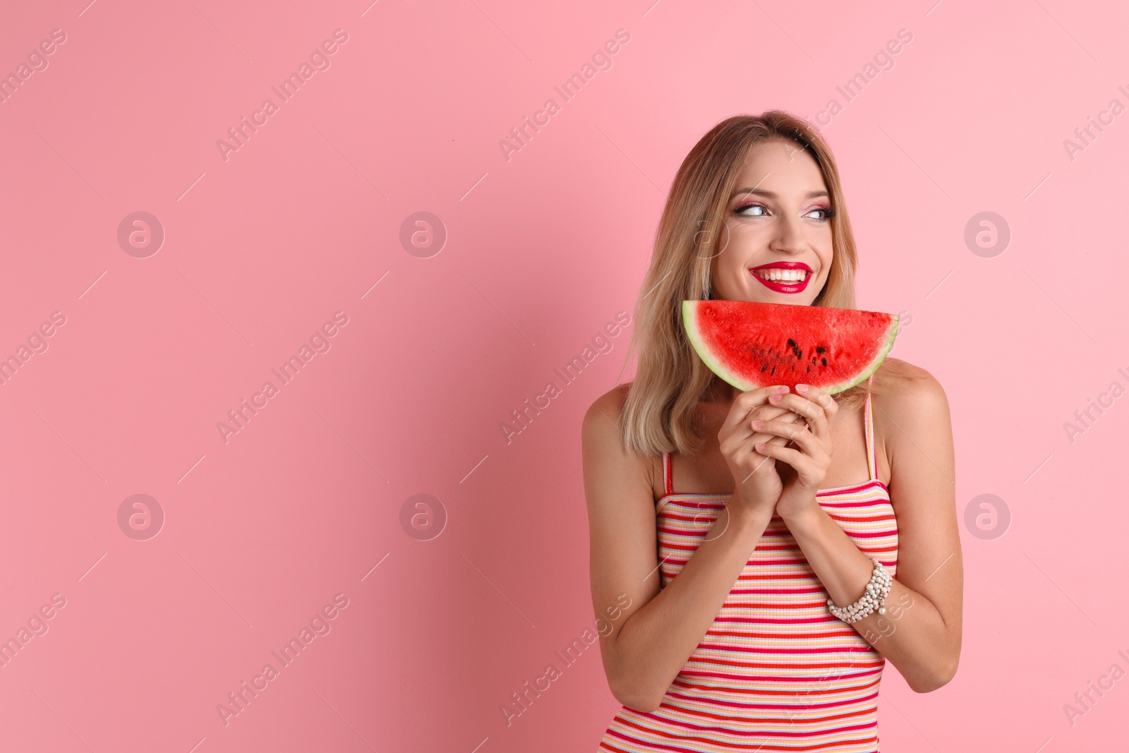 Photo of Pretty young woman with juicy watermelon on color background