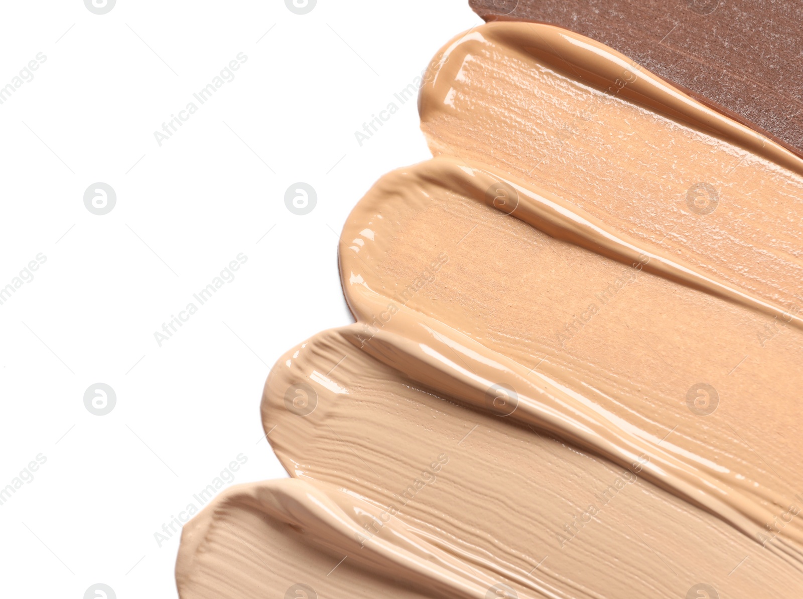 Photo of Samples of skin foundation on white background, closeup. Space for text
