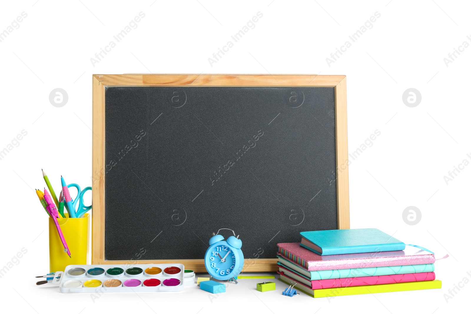 Photo of Different school stationery and small blank chalkboard on white background. Space for text