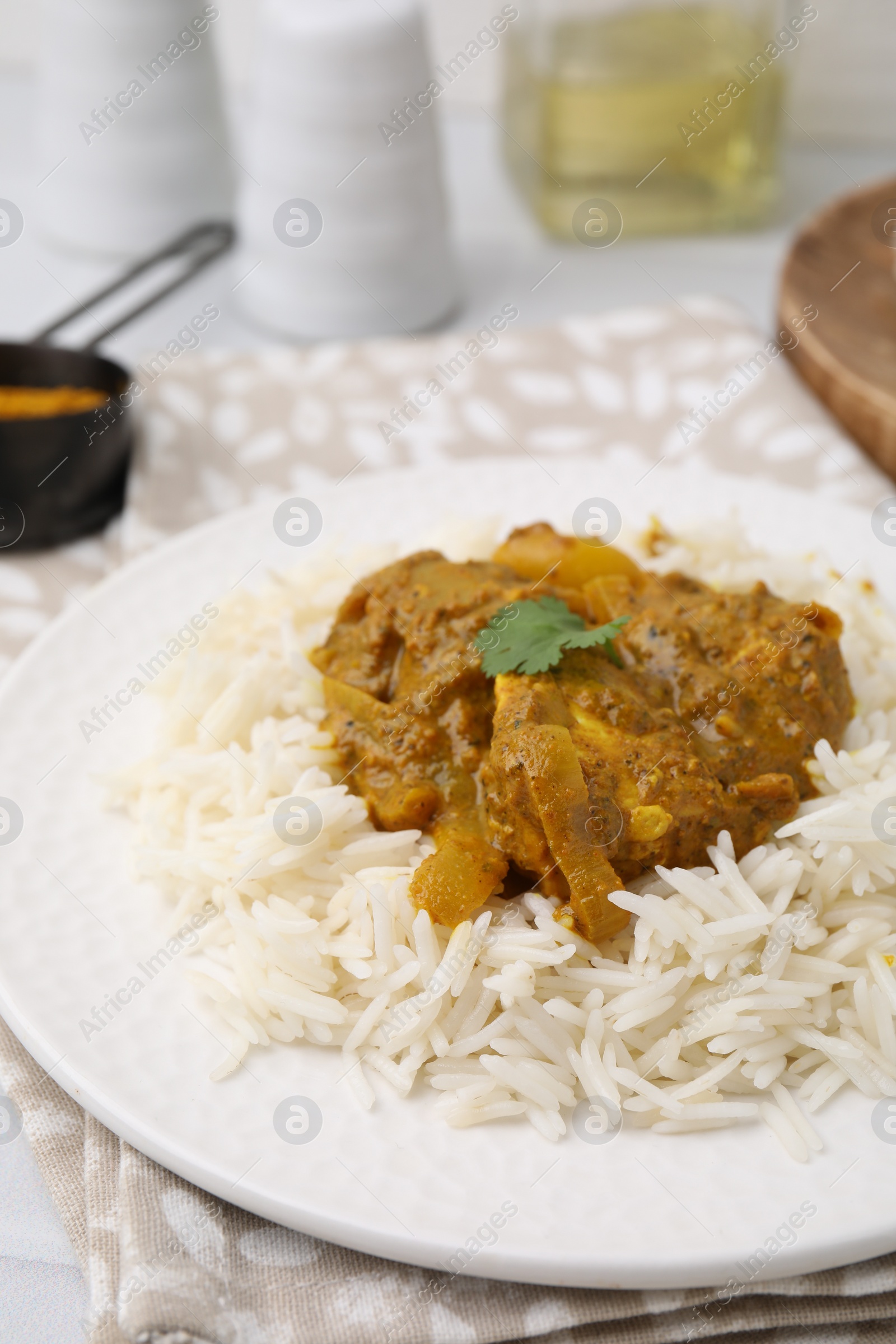 Photo of Delicious chicken curry with rice on table, closeup