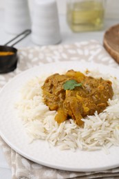 Photo of Delicious chicken curry with rice on table, closeup