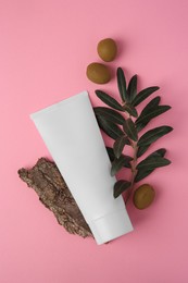 Natural cosmetic. Flat lay composition with olive cream on pink background