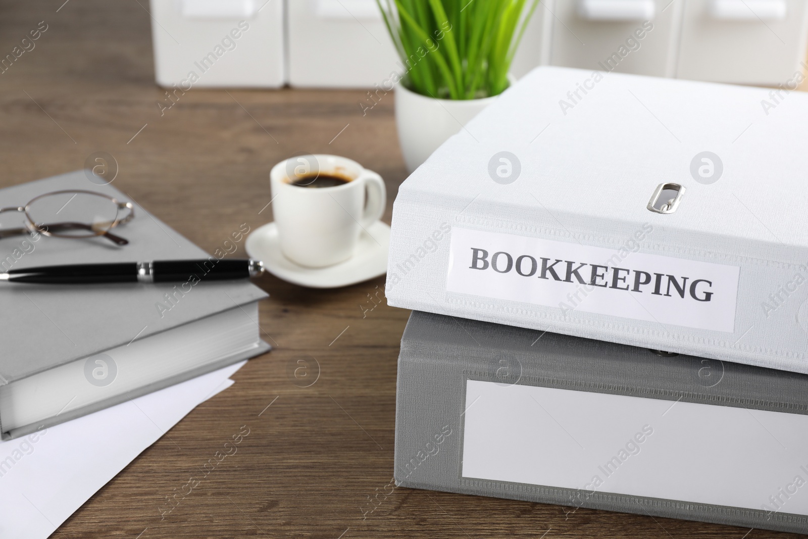 Photo of Folders and stationery on desk in office. Bookkeeper's workplace