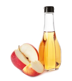 Photo of Glass bottle of vinegar and fresh apple on white background