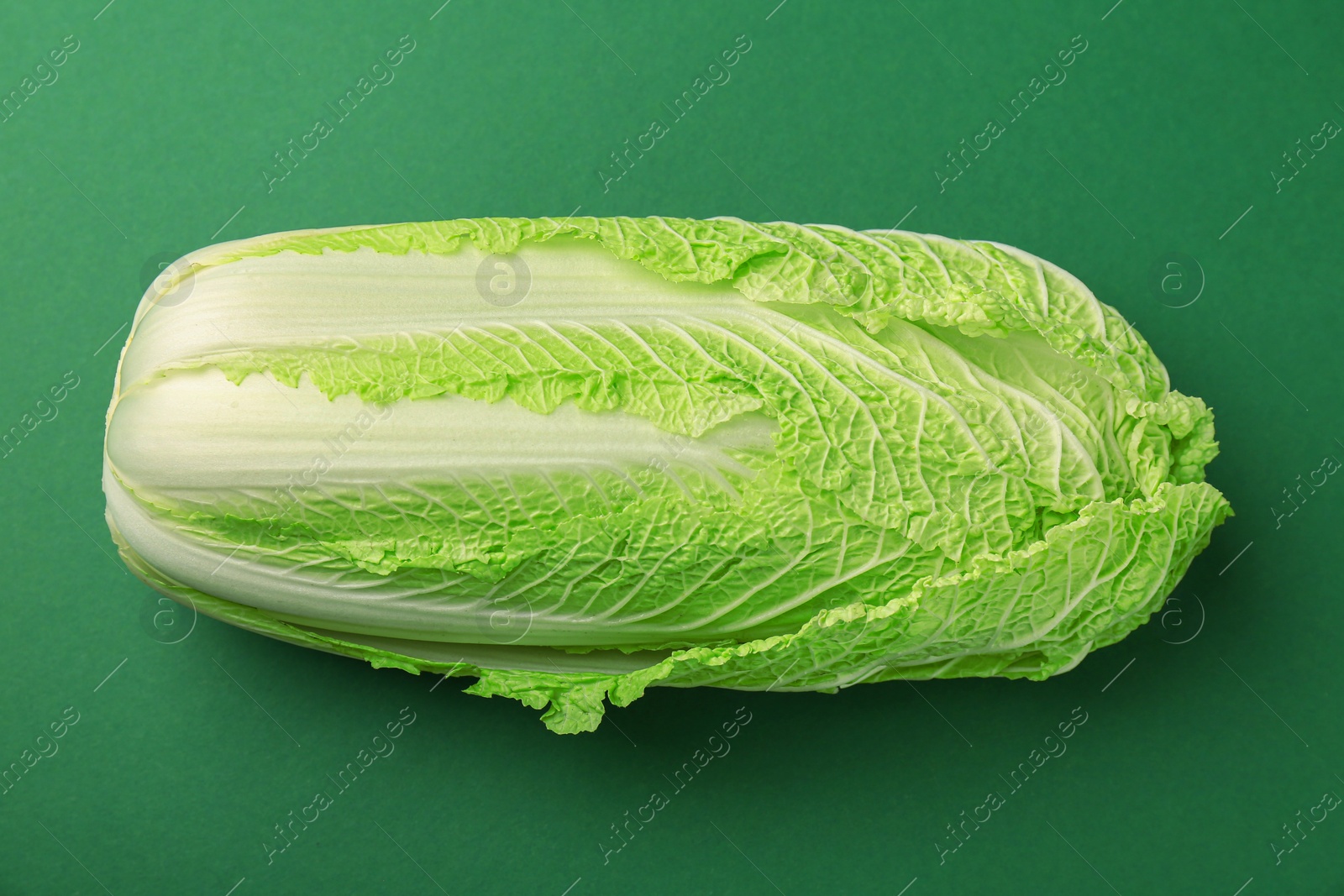 Photo of Fresh ripe Chinese cabbage on green background, top view